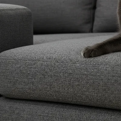 A close-up shot of a tightly woven, durable, scratch-resistant performance fabric on a sofa, showing its intricate texture and resilience against a cat's paw, detailed and realistic style